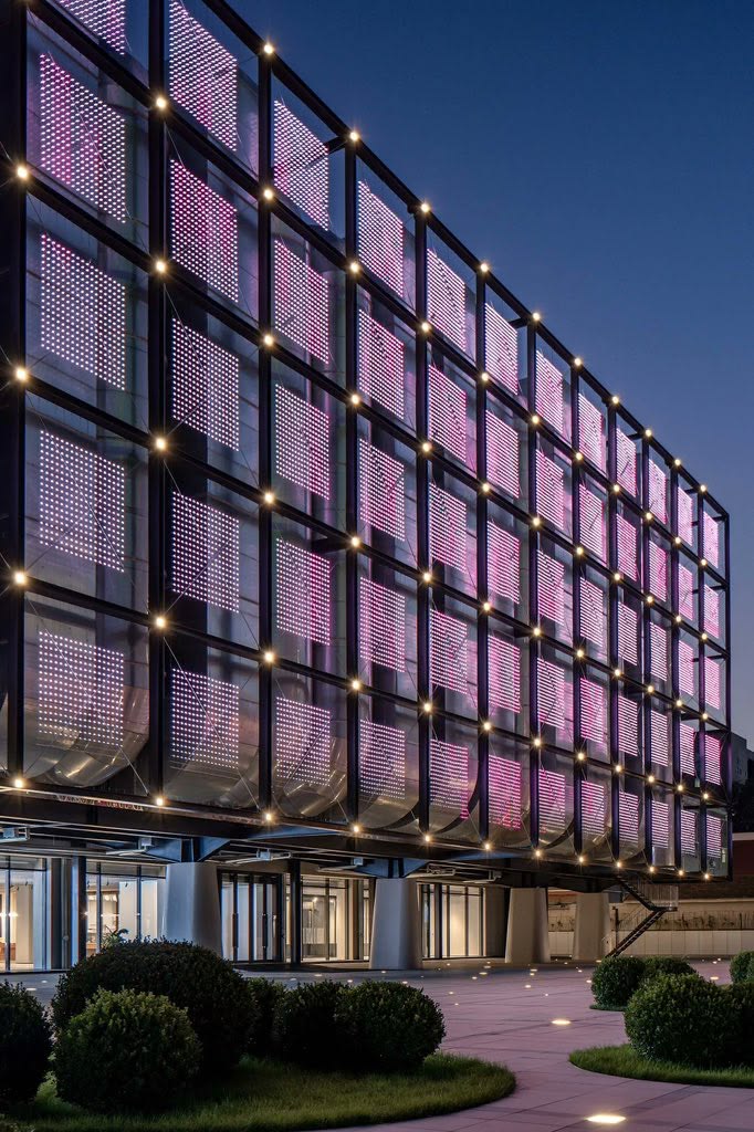 Illuminated architectural facade and infrastructure at dusk